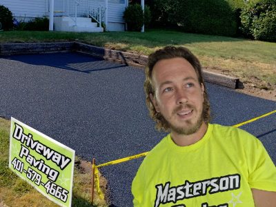 Masterson Paving owner in front of paved driveway AI